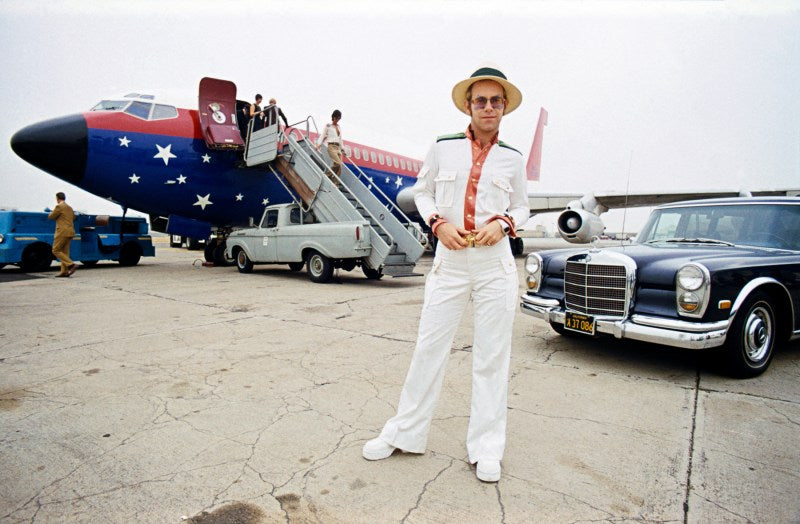 Elton John in front of Starship plane